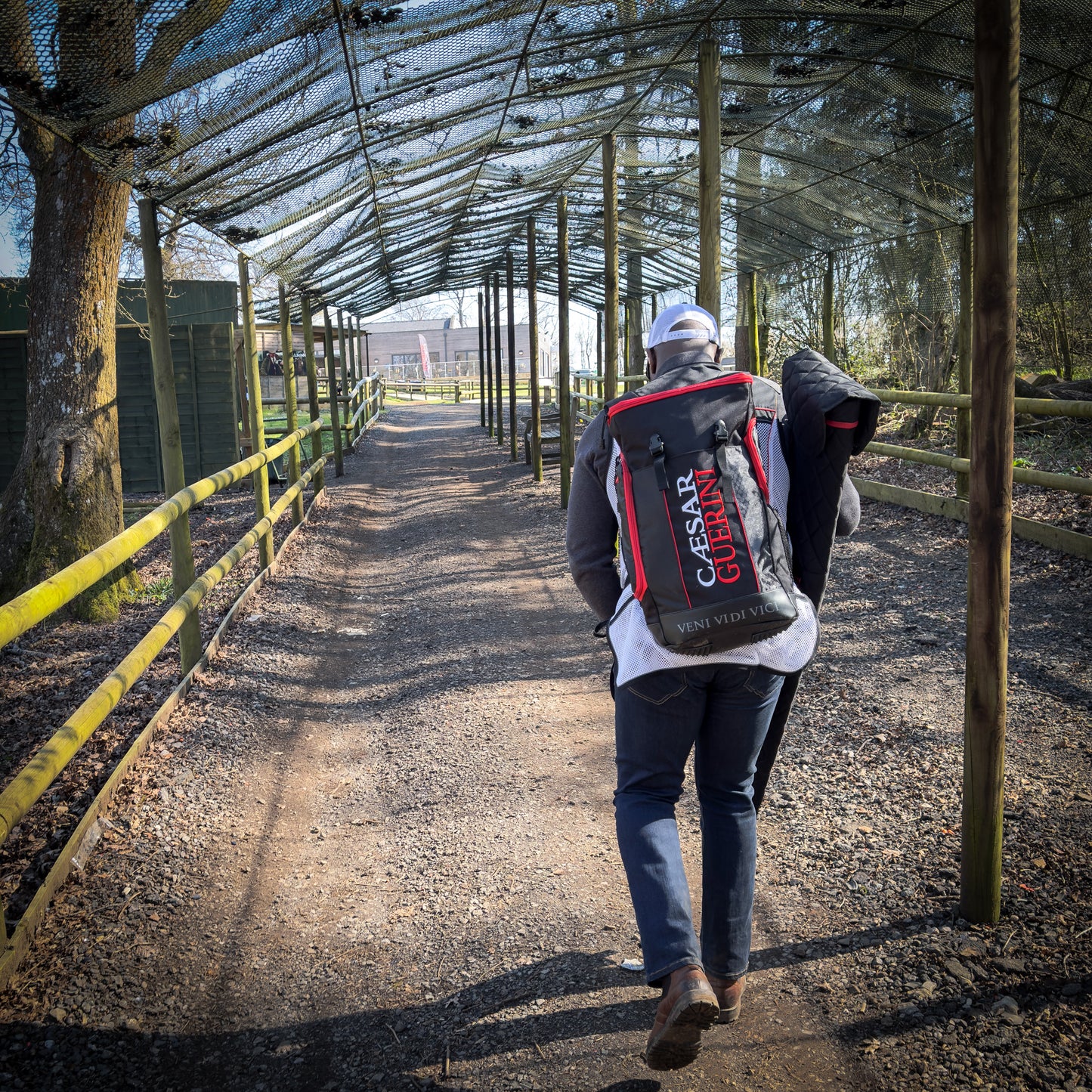 Person walking with a Caesar Carrion backpack in an outdoor setting