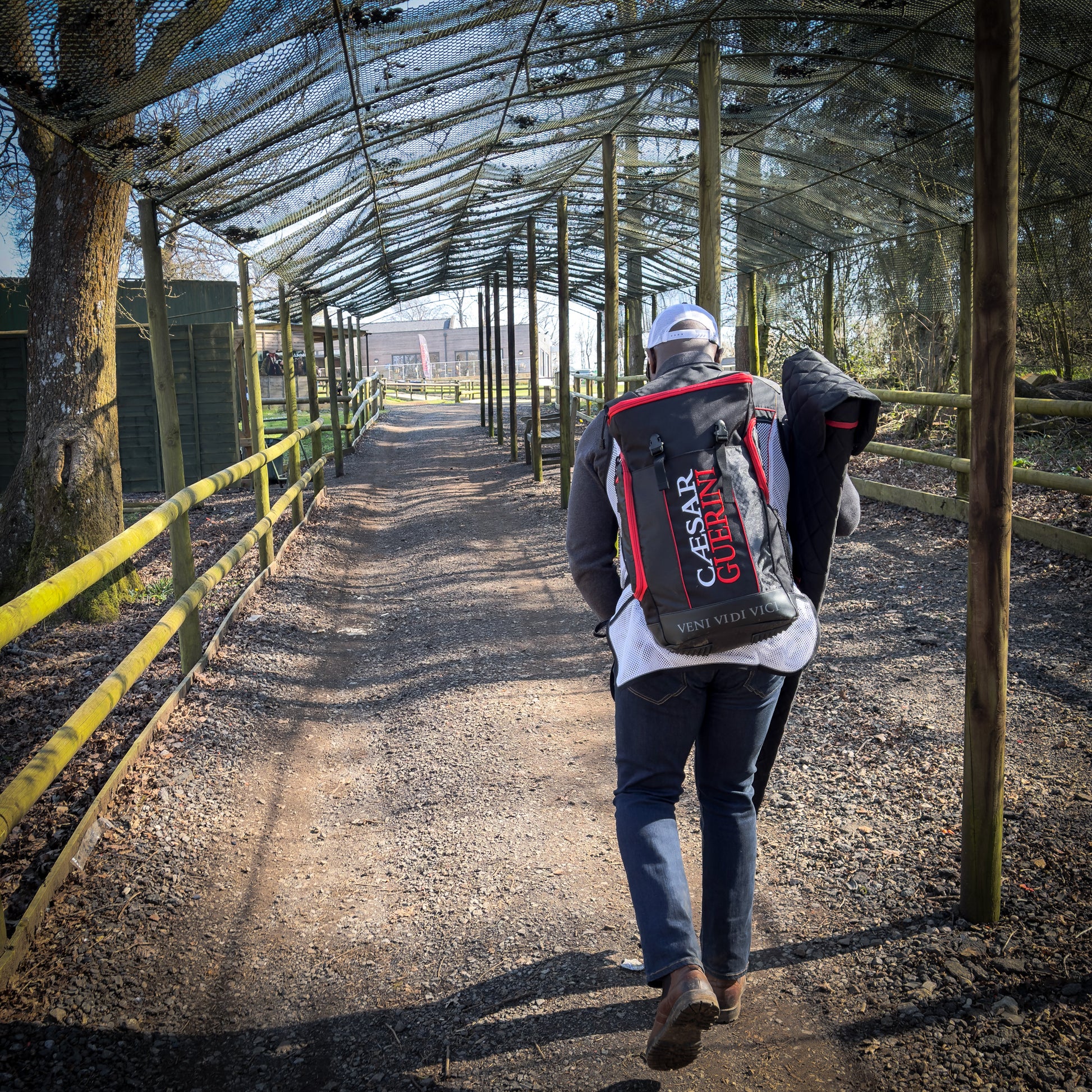 Person walking with a Caesar Carrion backpack in an outdoor setting
